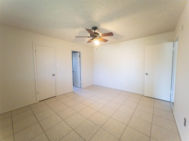 2907 Helmsley Dr, Pearland, TX 77584 - unfurnished room featuring ceiling fan, light tile patterned floors, and a textured ceiling