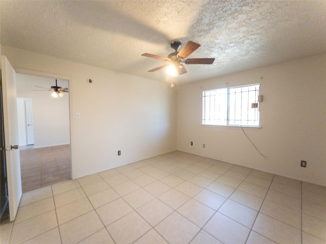 2907 Helmsley Dr, Pearland, TX 77584 - spare room with ceiling fan, a textured ceiling, and light tile patterned flooring