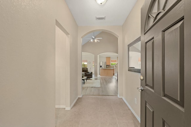 9226 Birch Springs Dr, Houston, TX 77095 - entrance foyer with ceiling fan, arched walkways, baseboards, and light tile patterned flooring