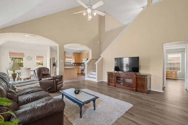 9226 Birch Springs Dr, Houston, TX 77095 - living area with arched walkways, a ceiling fan, high vaulted ceiling, and plenty of natural light