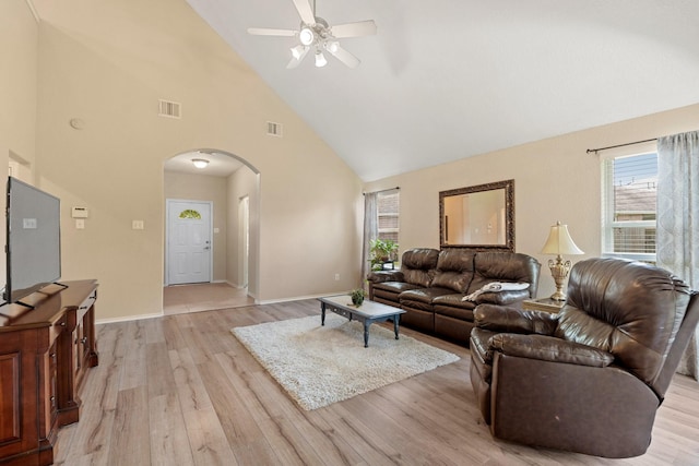9226 Birch Springs Dr, Houston, TX 77095 - living room with arched walkways, high vaulted ceiling, a ceiling fan, light wood-type flooring, and baseboards