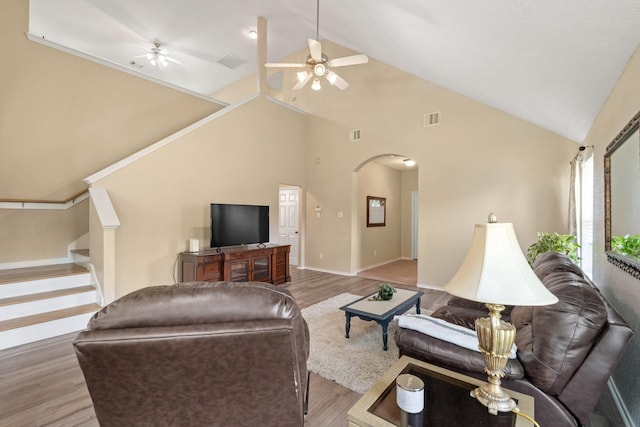9226 Birch Springs Dr, Houston, TX 77095 - living room with a ceiling fan, arched walkways, wood finished floors, stairway, and high vaulted ceiling