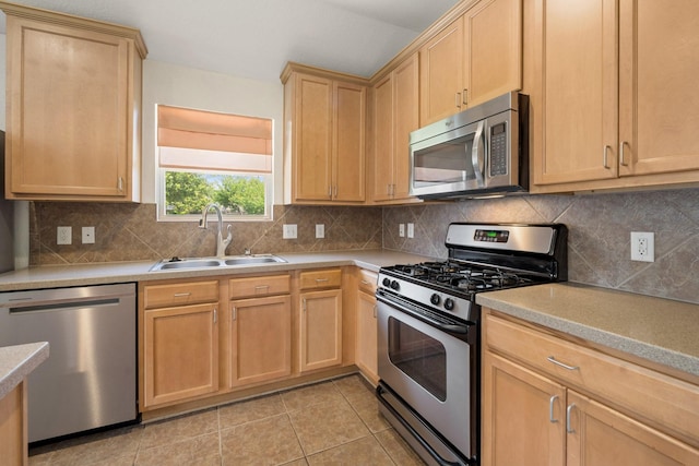 9226 Birch Springs Dr, Houston, TX 77095 - kitchen featuring appliances with stainless steel finishes, light brown cabinets, a sink, light countertops, and light tile patterned floors