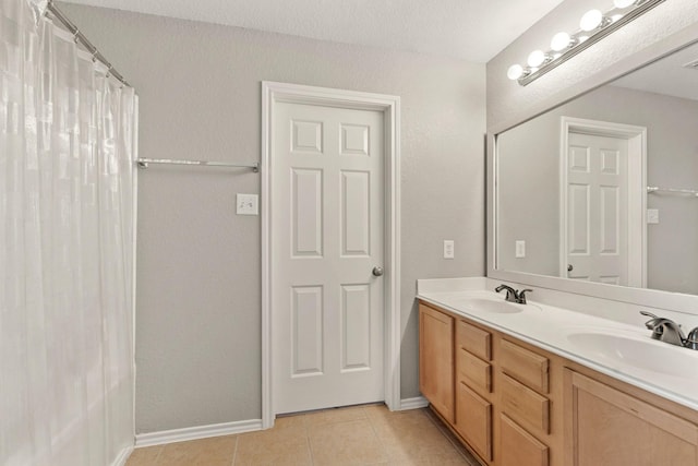 9226 Birch Springs Dr, Houston, TX 77095 - bathroom featuring double vanity, tile patterned flooring, baseboards, and a shower with curtain