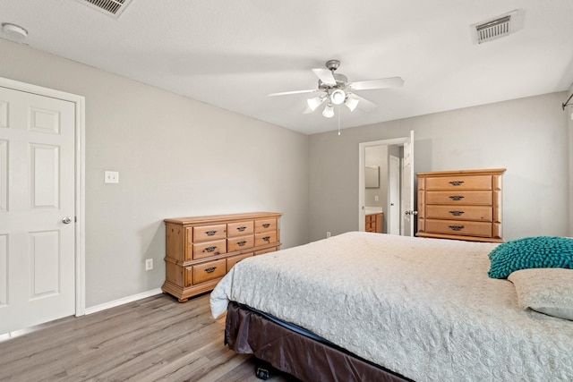9226 Birch Springs Dr, Houston, TX 77095 - bedroom with light wood finished floors, baseboards, a ceiling fan, and ensuite bathroom