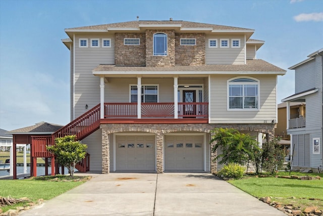21 Fleming, Hitchcock, TX 77563 - view of front facade featuring stone siding, driveway, a garage, and a front lawn