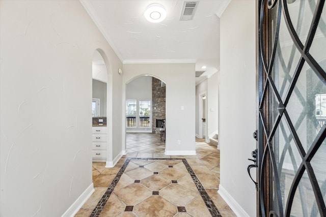 21 Fleming, Hitchcock, TX 77563 - entrance foyer with arched walkways, ornamental molding, baseboards, and inlaid floor details