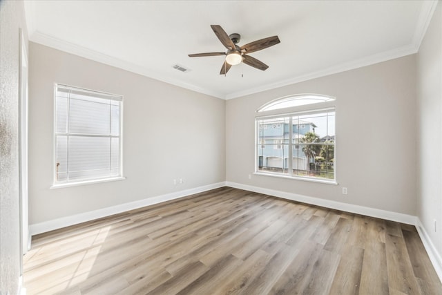 21 Fleming, Hitchcock, TX 77563 - empty room featuring crown molding, wood finished floors, a ceiling fan, and baseboards