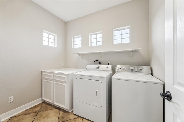 21 Fleming, Hitchcock, TX 77563 - laundry room featuring washer and clothes dryer, cabinet space, baseboards, and light tile patterned floors