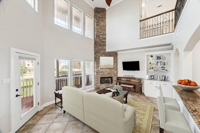 21 Fleming, Hitchcock, TX 77563 - living room with a high ceiling, a fireplace, and light tile patterned floors