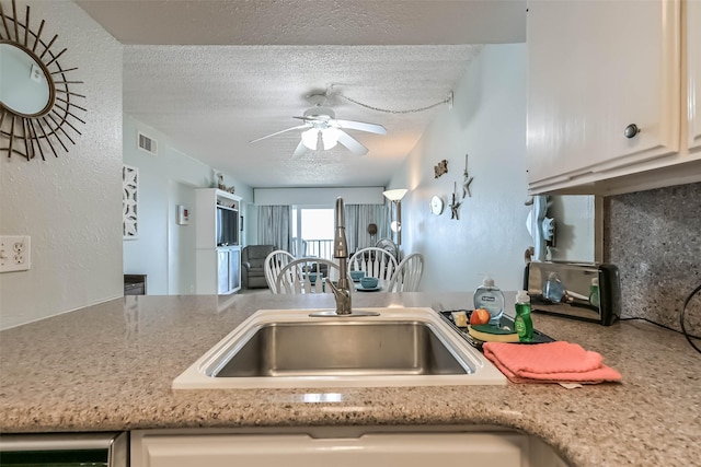 7310 Seawall Blvd Unit 907, Galveston, TX 77551 - kitchen with a sink, a textured ceiling, and ceiling fan