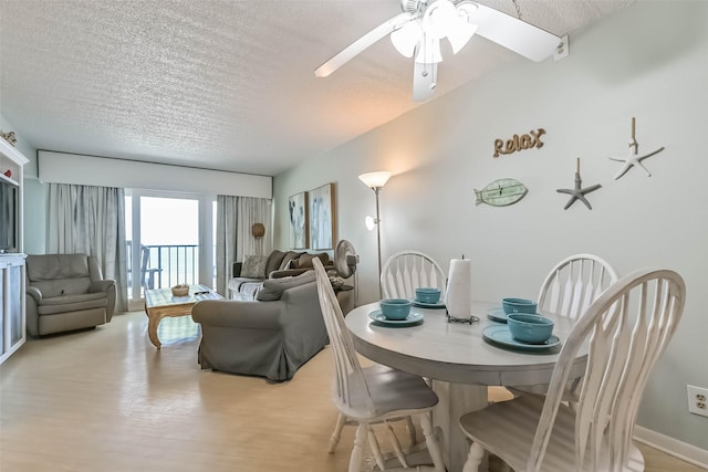 7310 Seawall Blvd Unit 907, Galveston, TX 77551 - dining space with a textured ceiling, light wood finished floors, and ceiling fan