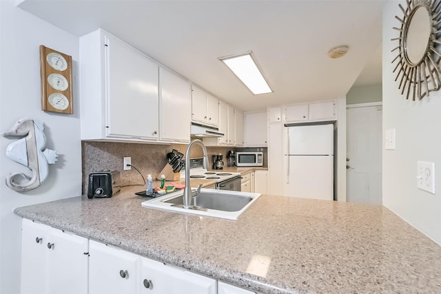 7310 Seawall Blvd Unit 907, Galveston, TX 77551 - kitchen with white appliances, under cabinet range hood, backsplash, and white cabinetry