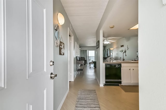 7310 Seawall Blvd Unit 907, Galveston, TX 77551 - corridor with a sink, light wood-style flooring, and baseboards