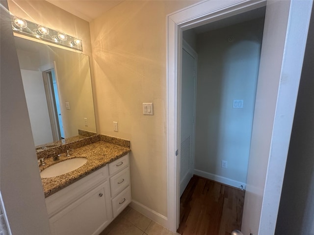 8710 Beverlyhill St Unit 102, Houston, TX 77063 - bathroom featuring vanity, baseboards, and wood finished floors