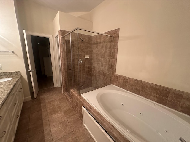 8710 Beverlyhill St Unit 102, Houston, TX 77063 - bathroom with a stall shower, a tub with jets, vanity, and tile patterned floors