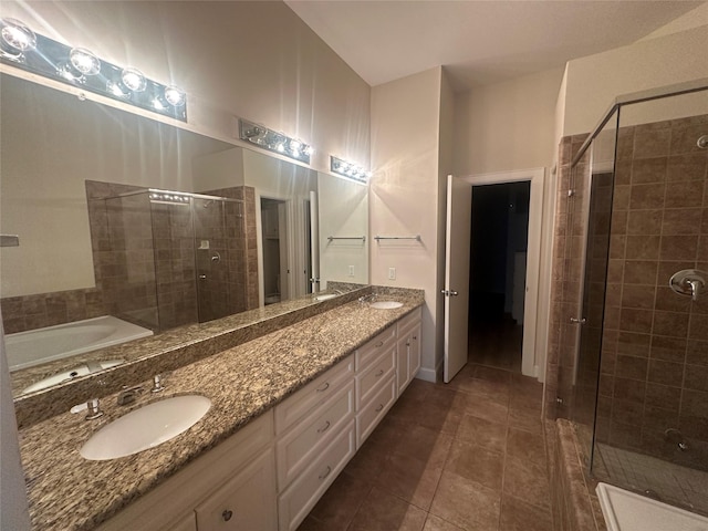 8710 Beverlyhill St Unit 102, Houston, TX 77063 - bathroom featuring a stall shower, tile patterned floors, double vanity, and a bath