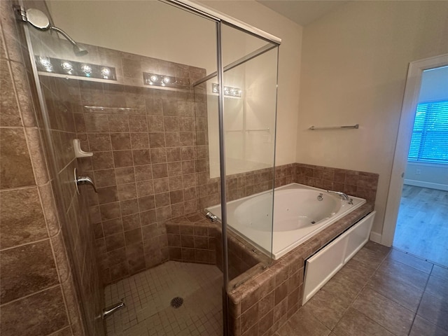8710 Beverlyhill St Unit 102, Houston, TX 77063 - bathroom with a shower stall, a bath, and tile patterned floors