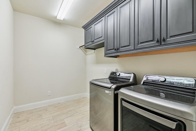 15411 Patten Forest Dr, Cypress, TX 77429 - washroom with washer and dryer, cabinet space, and baseboards