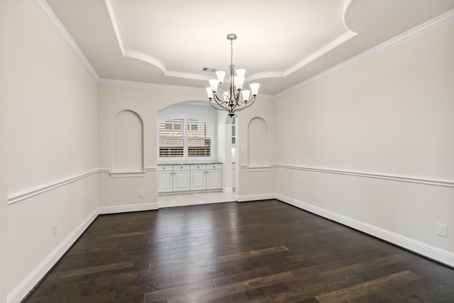 15411 Patten Forest Dr, Cypress, TX 77429 - unfurnished dining area with a tray ceiling, a chandelier, dark wood-type flooring, crown molding, and arched walkways