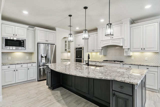 15411 Patten Forest Dr, Cypress, TX 77429 - kitchen with appliances with stainless steel finishes, a sink, white cabinets, decorative backsplash, and crown molding