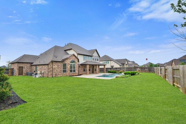 15411 Patten Forest Dr, Cypress, TX 77429 - back of property with brick siding, a patio area, cooling unit, and roof with shingles