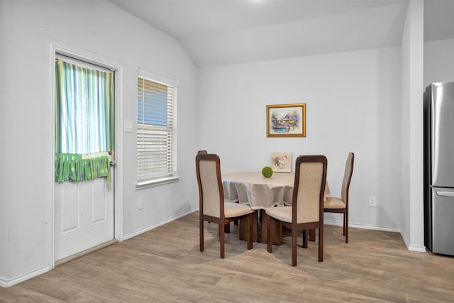 127 Barton Creek Dr, Huntsville, TX 77340 - dining room with vaulted ceiling, light wood-type flooring, and baseboards