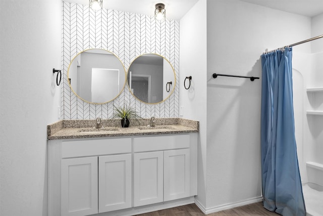 127 Barton Creek Dr, Huntsville, TX 77340 - full bath featuring double vanity, wood finished floors, curtained shower, baseboards, and backsplash