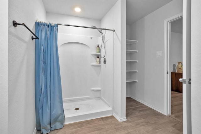 127 Barton Creek Dr, Huntsville, TX 77340 - bathroom with a stall shower and wood finished floors