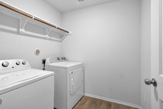 127 Barton Creek Dr, Huntsville, TX 77340 - laundry room with washing machine and dryer, dark wood-type flooring, and baseboards