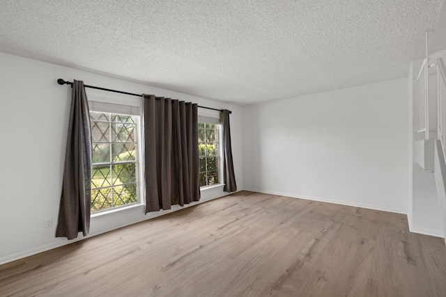 10320 Hammerly Blvd Unit 171, Houston, TX 77043 - empty room featuring wood finished floors, a textured ceiling, and baseboards