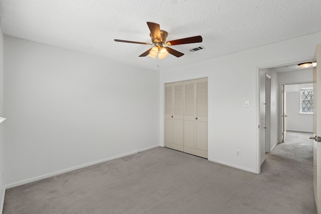 10320 Hammerly Blvd Unit 171, Houston, TX 77043 - unfurnished bedroom featuring carpet floors, baseboards, a closet, a textured ceiling, and a ceiling fan