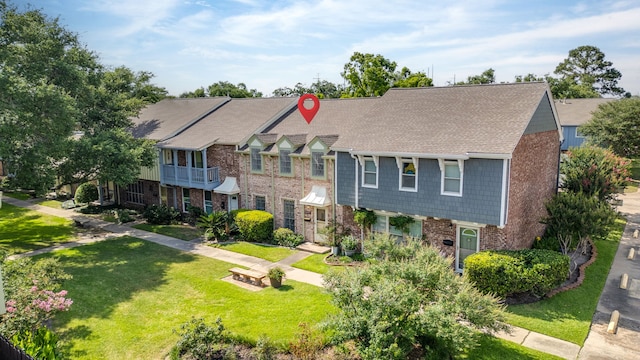 10320 Hammerly Blvd Unit 171, Houston, TX 77043 - view of front of property featuring brick siding, a front yard, and a shingled roof
