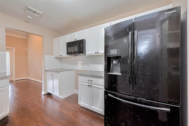24214 Soft Pine Dr, Huffman, TX 77336 - kitchen with black appliances, dark wood-type flooring, backsplash, white cabinets, and light stone countertops