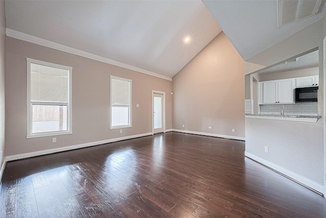 24214 Soft Pine Dr, Huffman, TX 77336 - unfurnished living room with vaulted ceiling, dark wood-type flooring, crown molding, baseboards, and recessed lighting