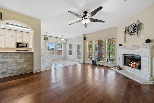 8002 Elm Wood Ct, Baytown, TX 77523 - unfurnished living room with a premium fireplace, wood-type flooring, and a ceiling fan
