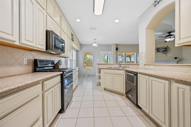 8002 Elm Wood Ct, Baytown, TX 77523 - kitchen with range with two ovens, a sink, dishwasher, cream cabinetry, and recessed lighting