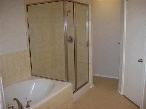 7631 Ashton Dr, Houston, TX 77095 - bathroom featuring a stall shower and a garden tub