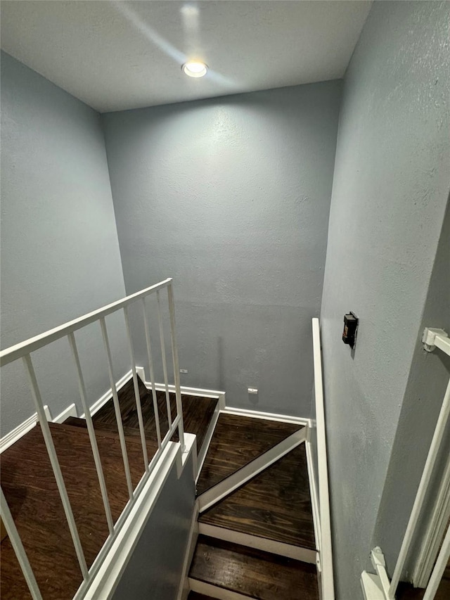 8007 E Oakwood Ct, Houston, TX 77040 - stairway featuring wood finished floors and a textured wall