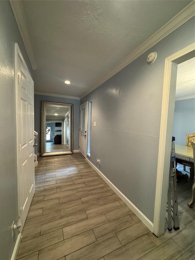 8007 E Oakwood Ct, Houston, TX 77040 - hallway featuring wood finished floors, ornamental molding, baseboards, and a textured ceiling