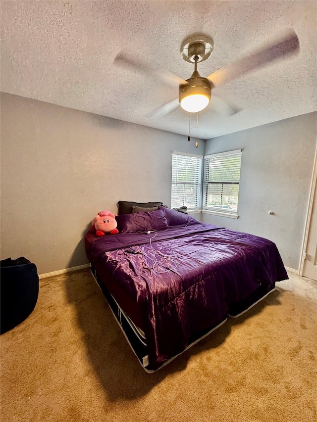 8007 E Oakwood Ct, Houston, TX 77040 - carpeted bedroom with a textured ceiling, baseboards, and a ceiling fan