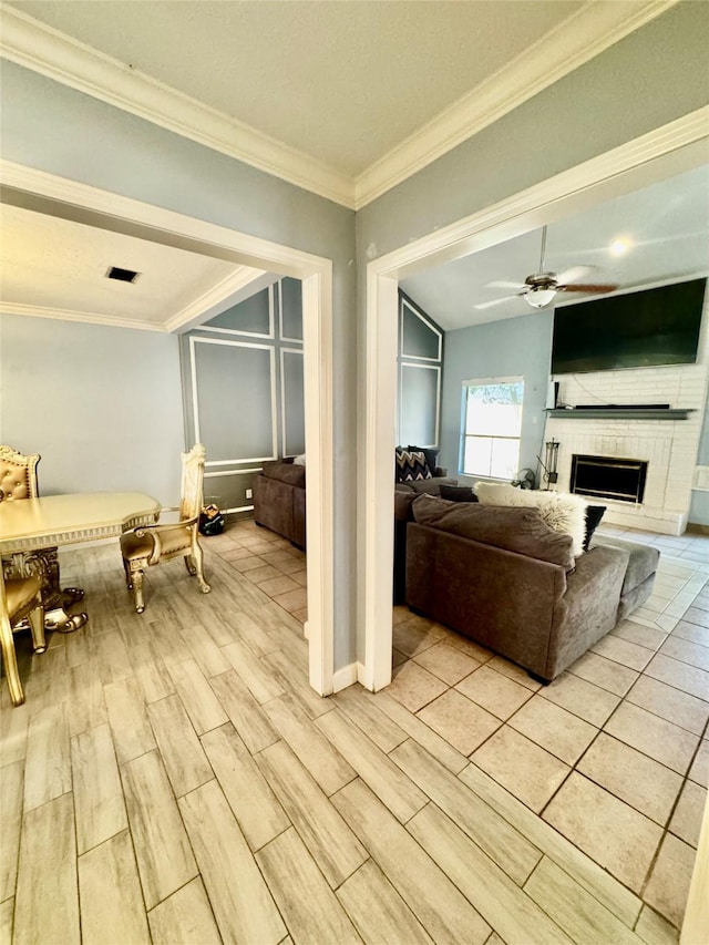 8007 E Oakwood Ct, Houston, TX 77040 - living area with ornamental molding, light wood-type flooring, a ceiling fan, and a large fireplace