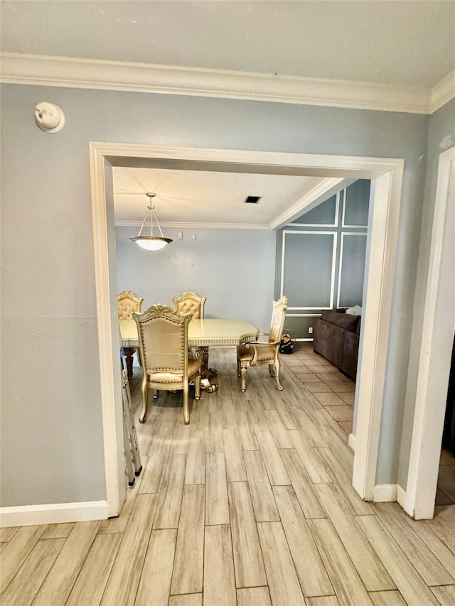 8007 E Oakwood Ct, Houston, TX 77040 - dining space featuring light wood-style flooring, crown molding, and baseboards