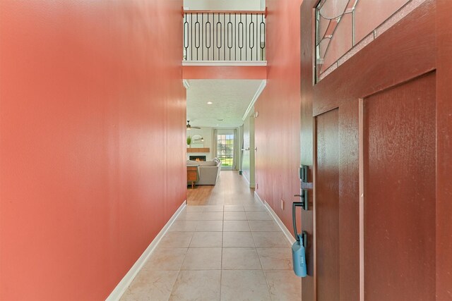 1017 Oak Knoll Ct, Sugar Land, TX 77498 - hall featuring a towering ceiling, baseboards, and tile patterned floors