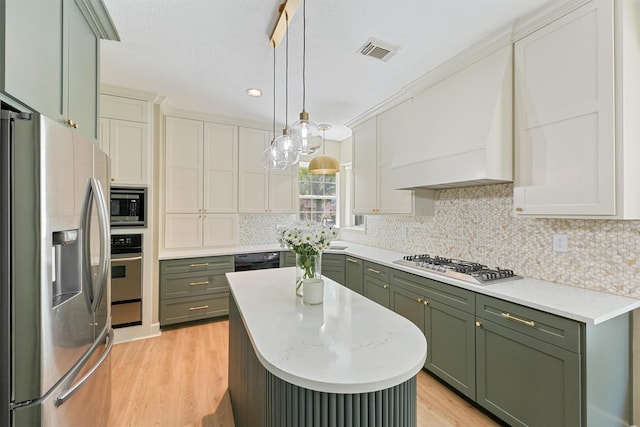1017 Oak Knoll Ct, Sugar Land, TX 77498 - kitchen with green cabinets, stainless steel appliances, premium range hood, light wood-style flooring, and recessed lighting