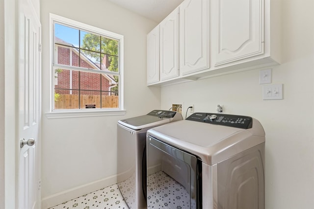 1017 Oak Knoll Ct, Sugar Land, TX 77498 - laundry room featuring cabinet space, baseboards, washer and clothes dryer, and light floors