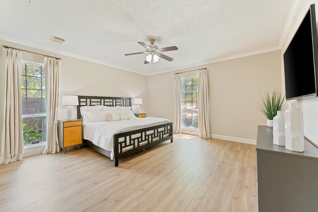 1017 Oak Knoll Ct, Sugar Land, TX 77498 - bedroom with light wood-type flooring, crown molding, baseboards, ceiling fan, and a textured ceiling