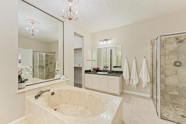 1017 Oak Knoll Ct, Sugar Land, TX 77498 - full bathroom featuring a chandelier, a shower stall, vanity, a tub with jets, and baseboards