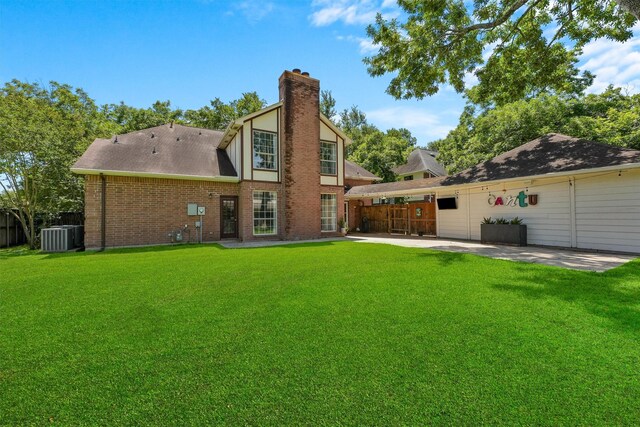 1017 Oak Knoll Ct, Sugar Land, TX 77498 - rear view of property featuring a patio area, a chimney, brick siding, central air condition unit, and roof with shingles