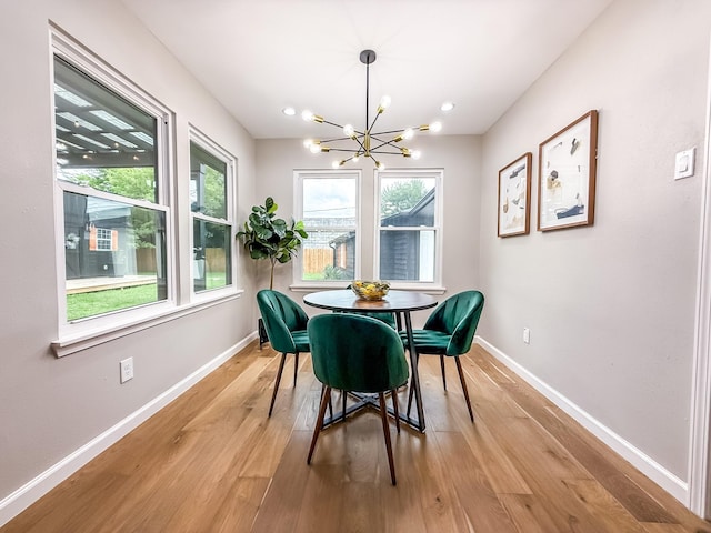 2106 Teague Rd, Houston, TX 77080 - dining space featuring baseboards, a chandelier, and light wood finished floors
